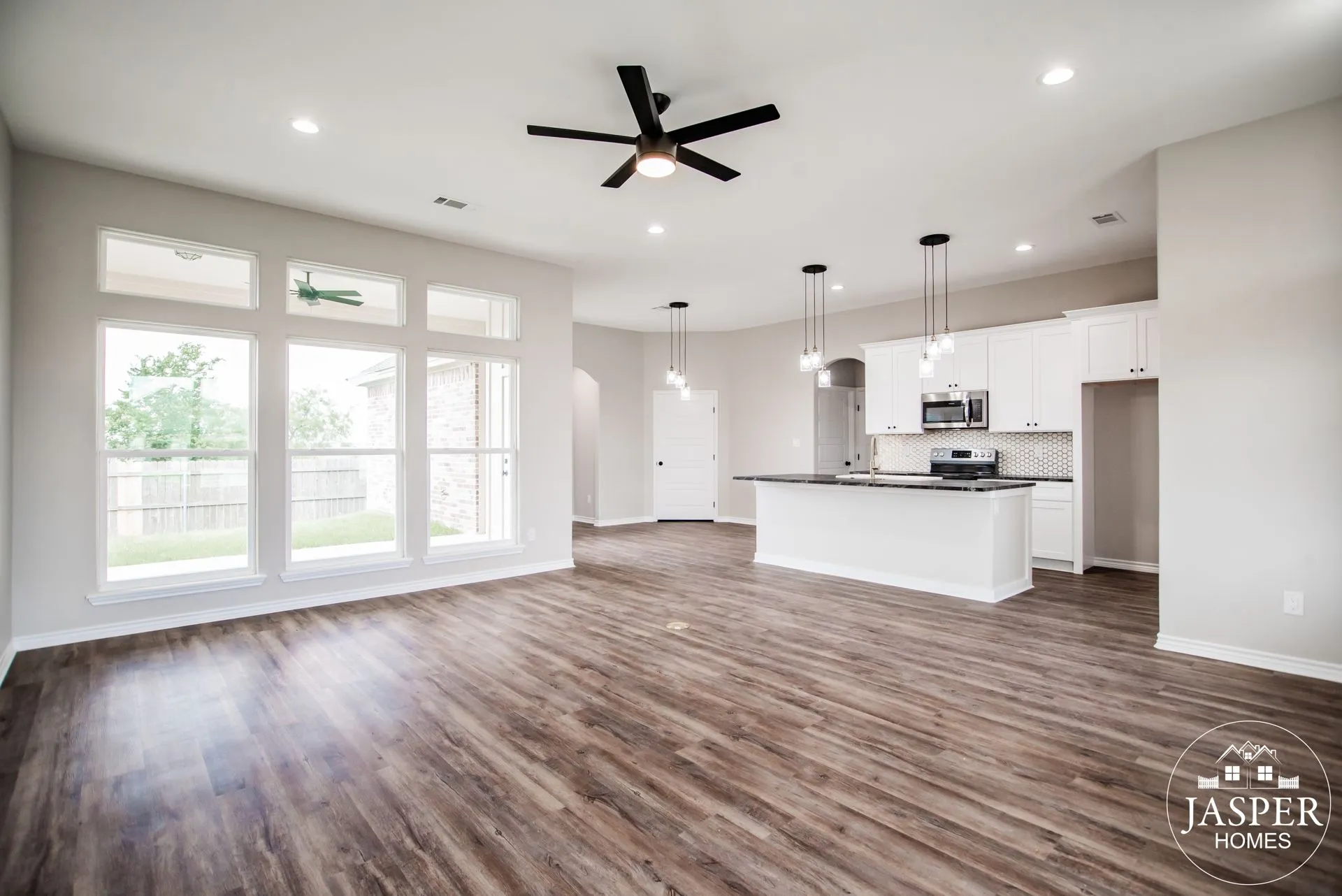 Open concept living room and kitchen with wood plank floors