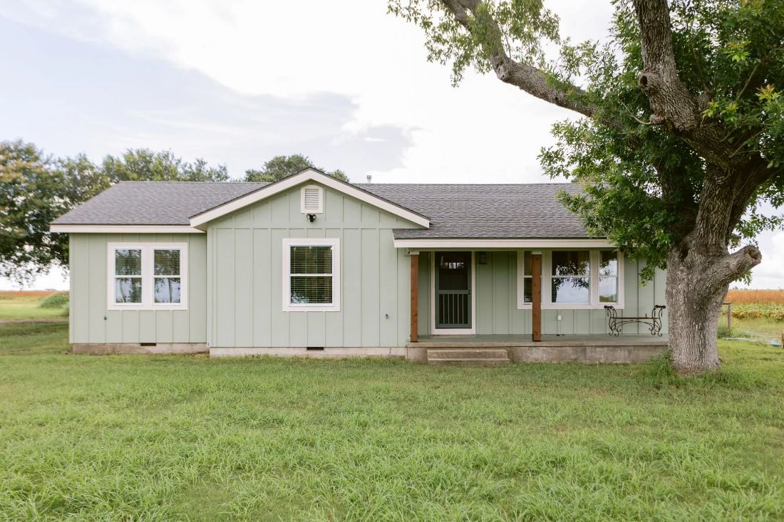 Remodeled sage green country home with covered porch