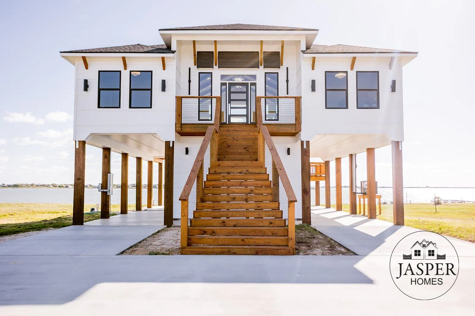 Elevated waterfront custom home with cedar stairs on the bay