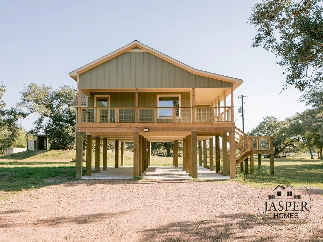 Elevated ranch house on pilings with wraparound porch